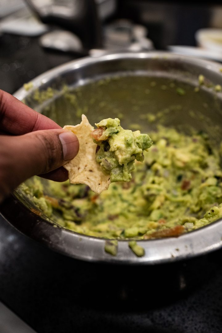 Tortilla chip dipped in fresh guacamole