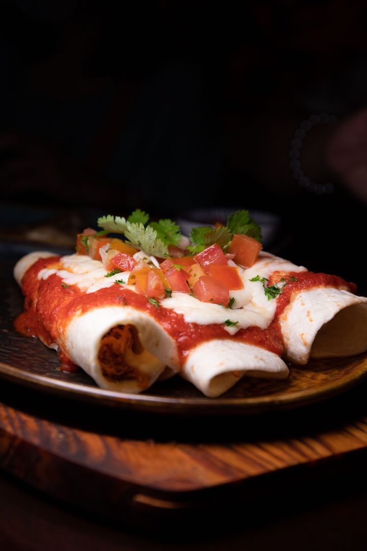 Enchiladas with red sauce and herbs